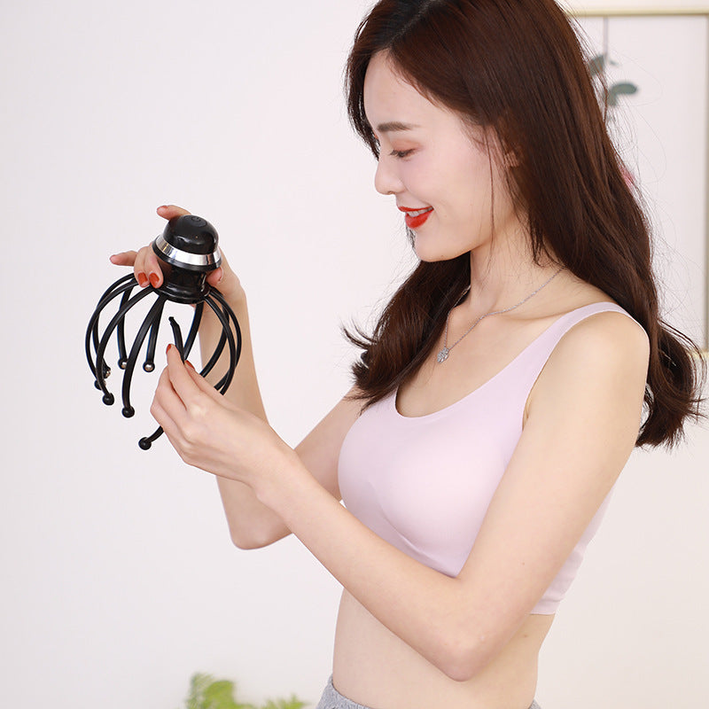 12-Claw Vibrating Scalp Massage Device - Woman holding a black hair styling tool against a white background