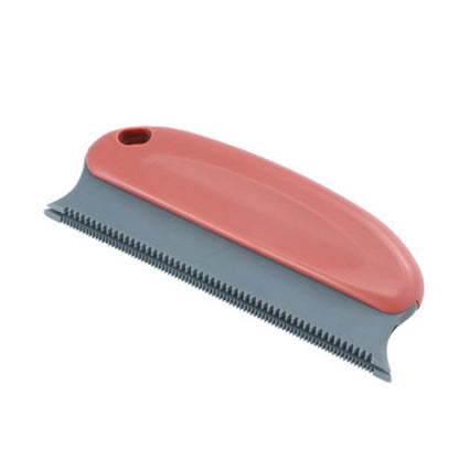 Pet grooming brush with red handle and gray bristle side on a white background