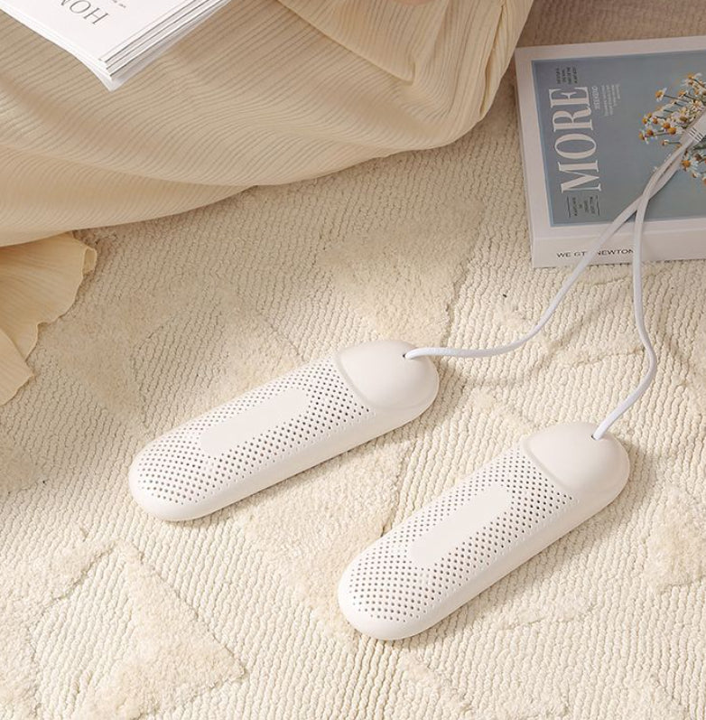 White heating pads on a textured surface with books in the background