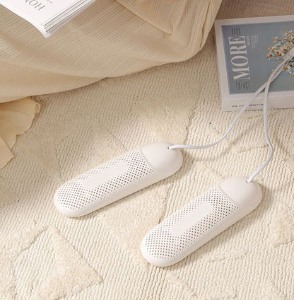 White heating pads on a textured surface with books in the background