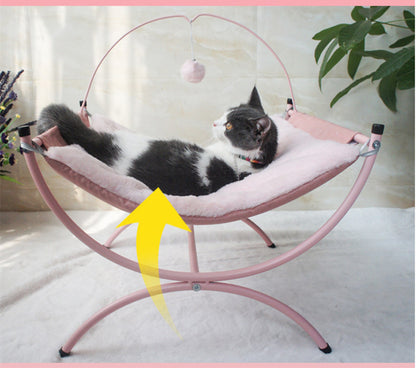 Cat lying on a pink pet hammock with a yellow arrow pointing to it.