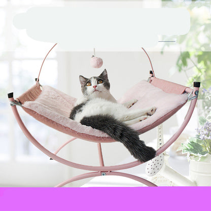 Cat lounging on a pink pet hammock with a blurred background