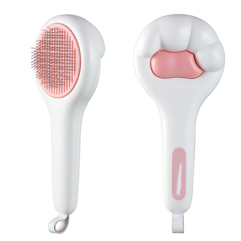 White and pink grooming brush on a white background