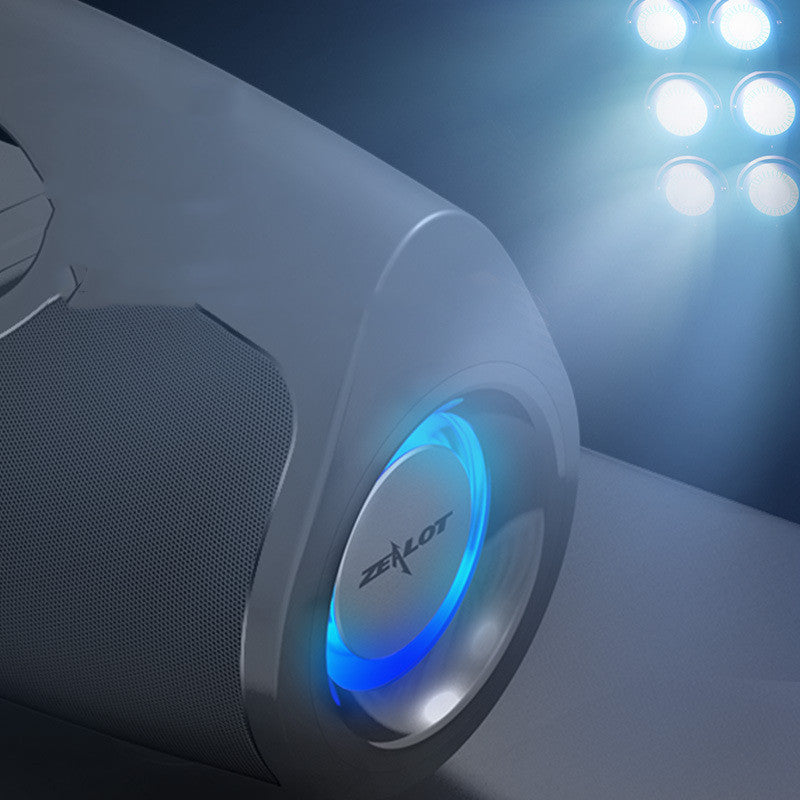 Gaming mouse with blue light and 'Zealot' branding on a dark background