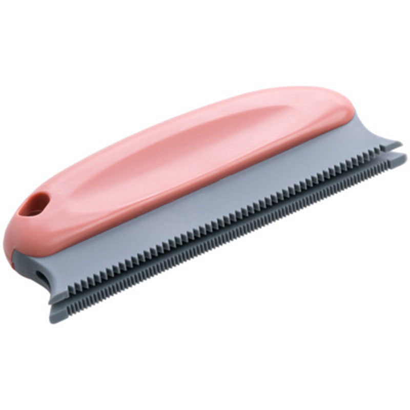 Pet grooming brush with pink handle and gray bristle side on a white background