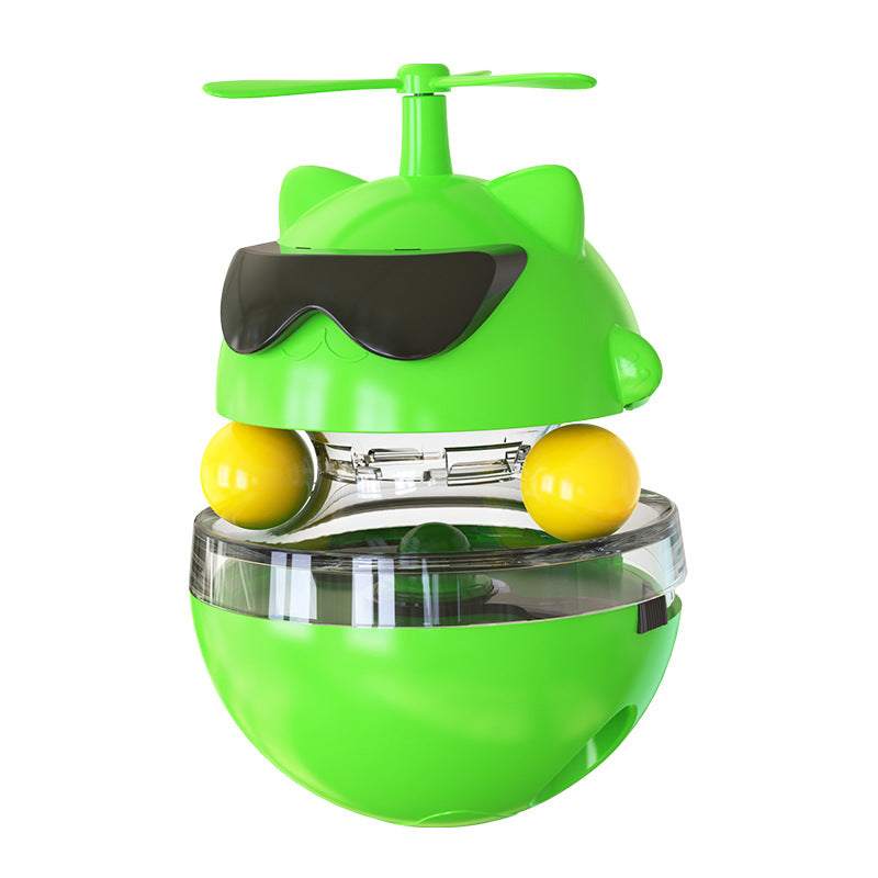 Green toy with yellow balls and a propeller on a white background
