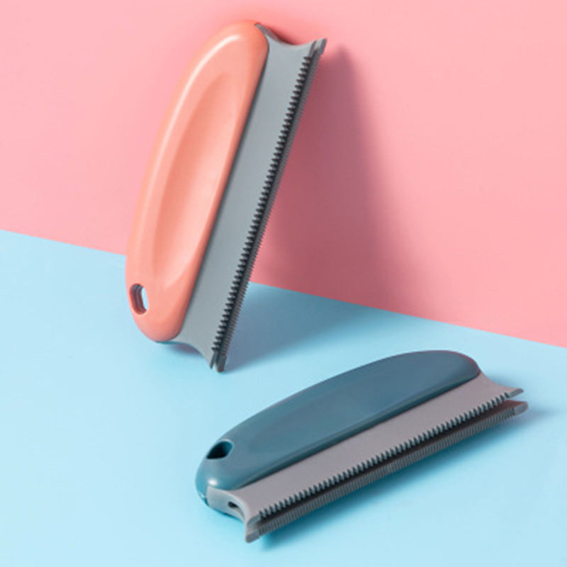 Two pet grooming tools with pink and blue handles on a pink and blue background