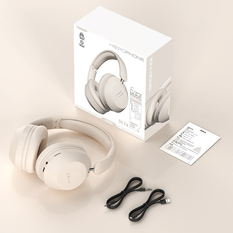 Wireless Gaming Bluetooth Over-Ear Headphones - White headphones with packaging, cables, and user manual on a beige surface