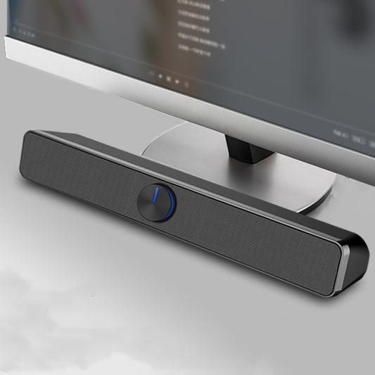 Black soundbar with a blue light on a gray surface