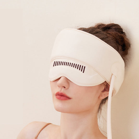 Woman wearing a white sleep mask with a neutral background
