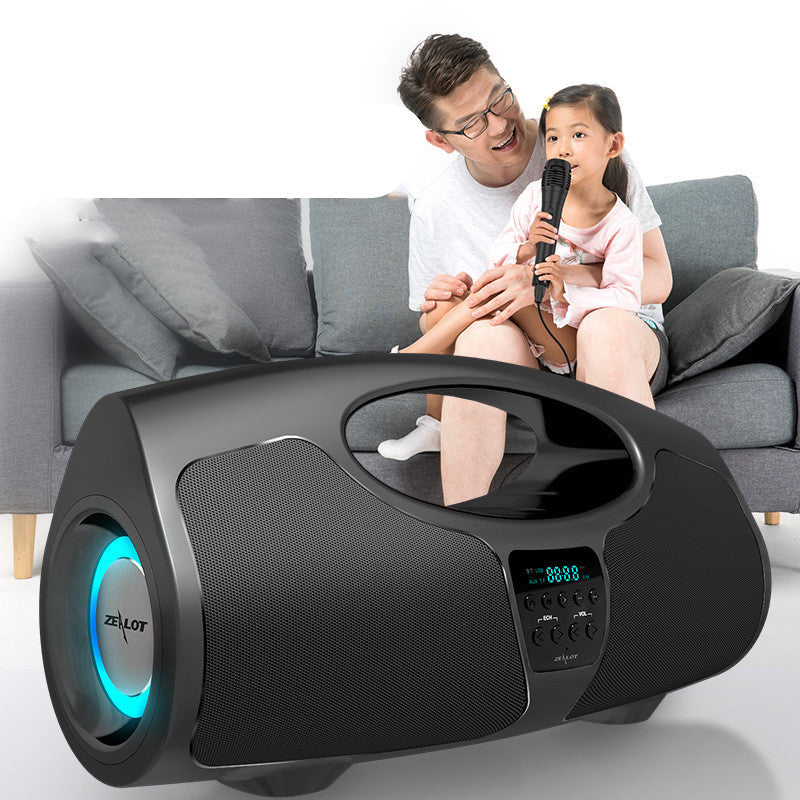 Black speaker with blue light on a white background, featuring a man and child sitting on a couch.