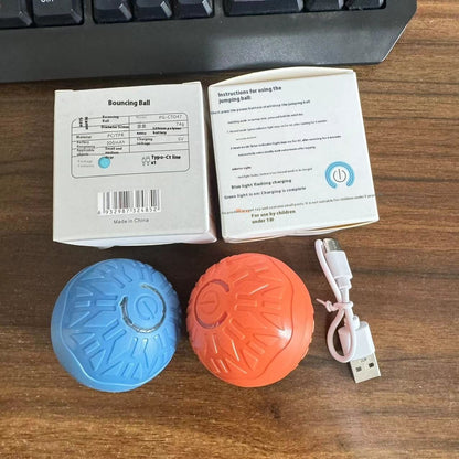 Two colorful balls and a USB cable on a wooden surface with packaging and instructions.