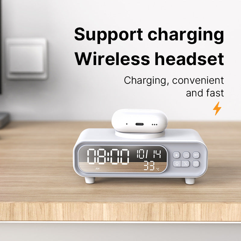 White alarm clock with wireless headset charging on a wooden surface