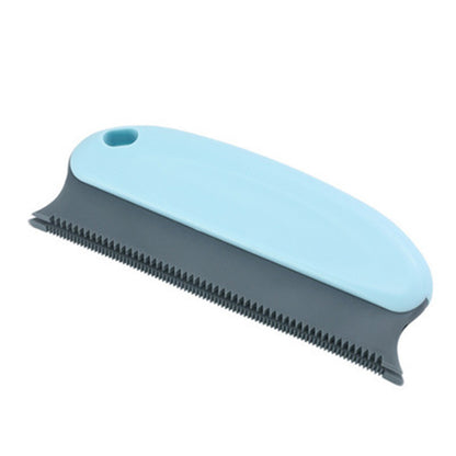 Pet grooming brush with blue handle and black bristles on a white background