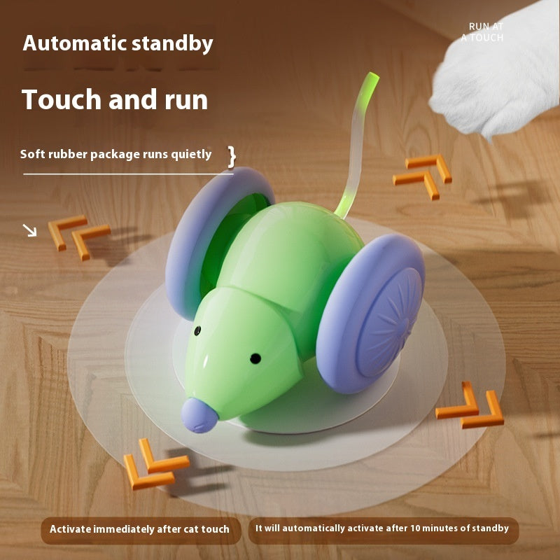 Toy mouse with green body and purple wheels on a wooden surface, featuring text about automatic standby and touch and run functions.