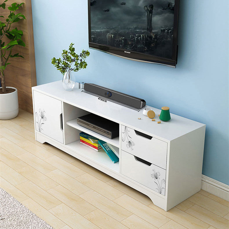 White TV stand with decorative items against a light blue wall.
