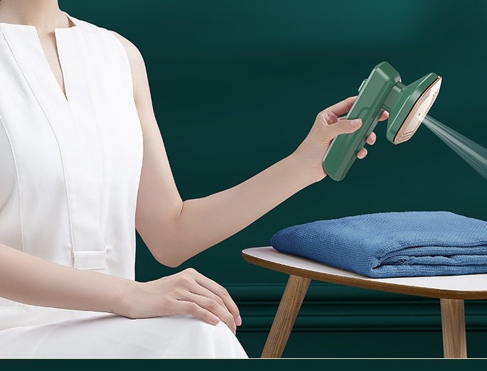 Person ironing a garment with a green iron against a dark green background