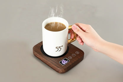 Hand holding a mug of steaming coffee on a wooden mug warmer with digital display, branded Luckima.