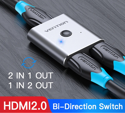 A Vention HDMI 2.0 bi-direction switch adapter with a silver metal body, black and blue plastic connectors, and blue LED indicator light, shown on a dark wood background with product text overlays.