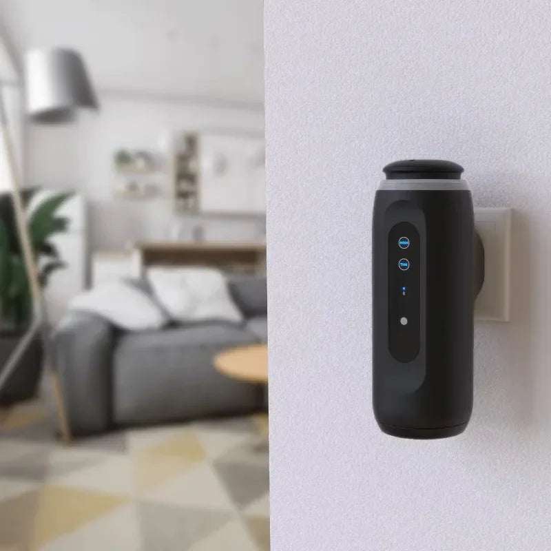 Black air purifier attached to a wall in a living room setting