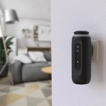 Black air purifier attached to a wall in a living room setting
