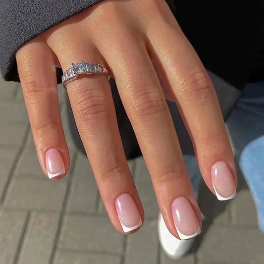 Hand with a diamond ring on a blurred background