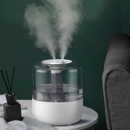 Humidifier emitting steam on a table with a dark green background