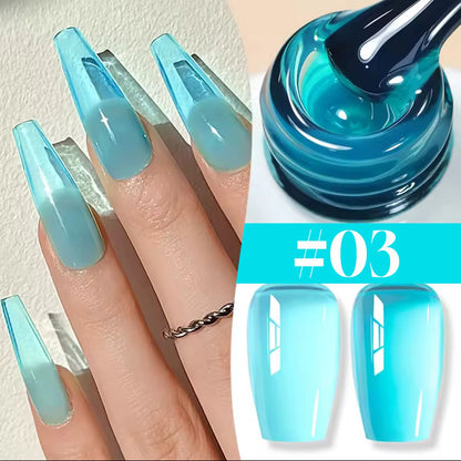 Blue gradient nail design with a bottle of blue nail polish.