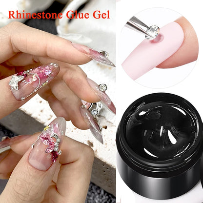 Nail art with rhinestones and a container of rhinestone glue gel.