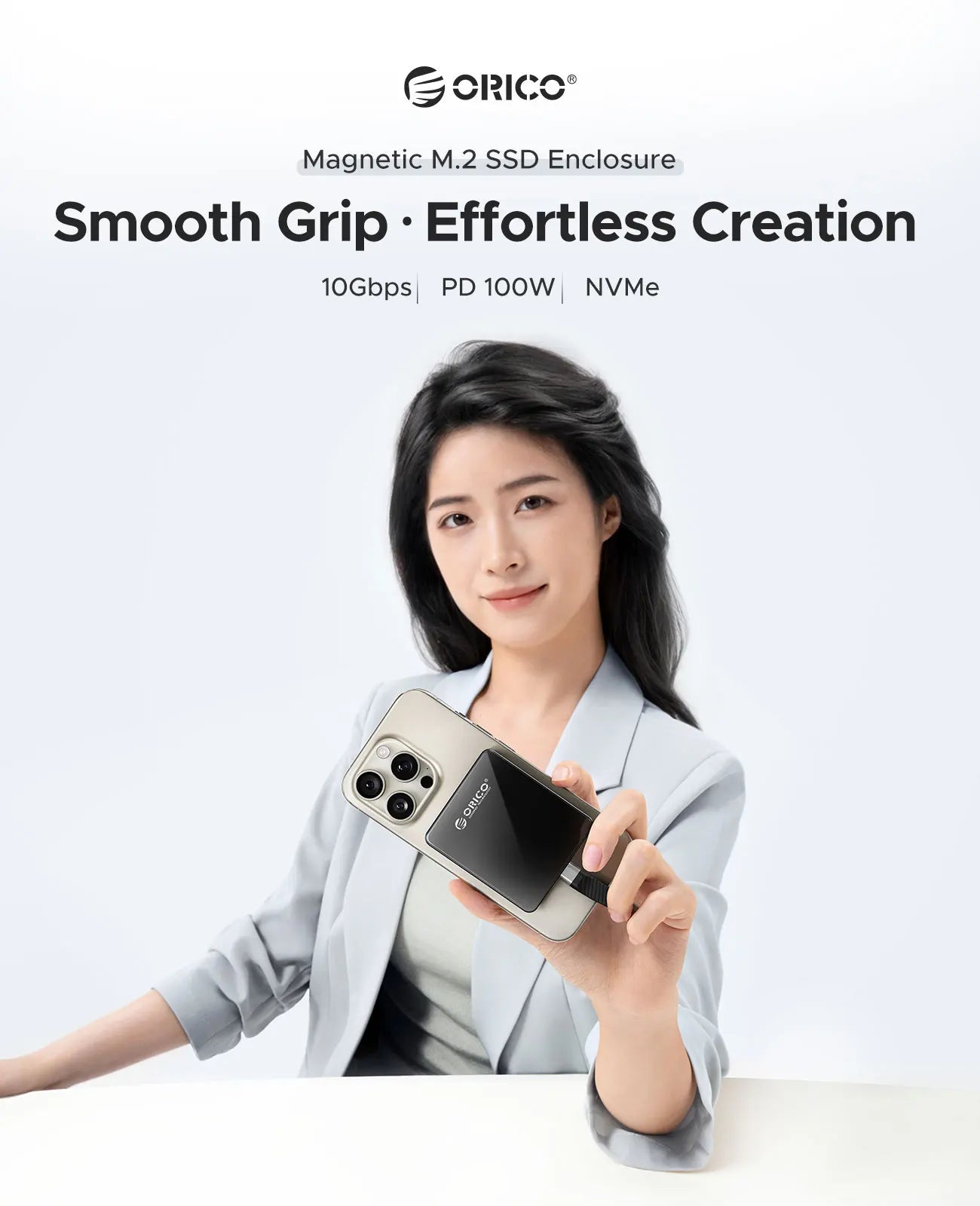 Woman holding a magnetic M.2 SSD enclosure with Orico branding on a white background