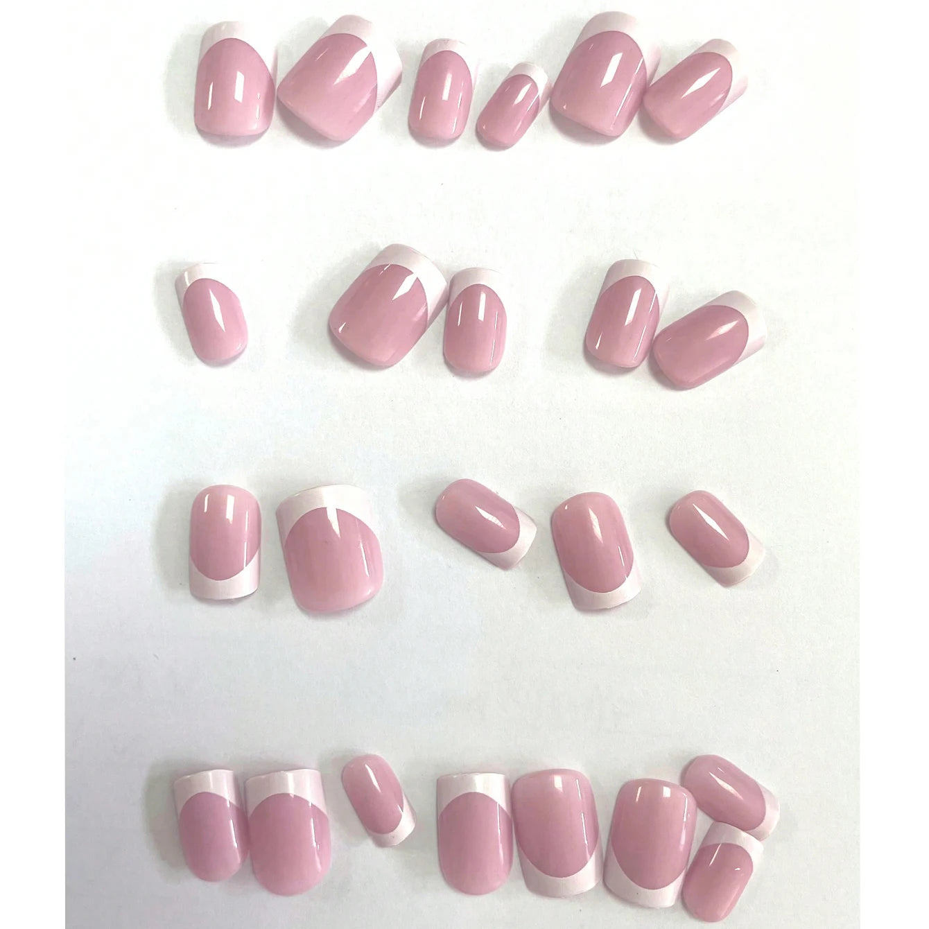 Set of pink and white nail tips on a white background