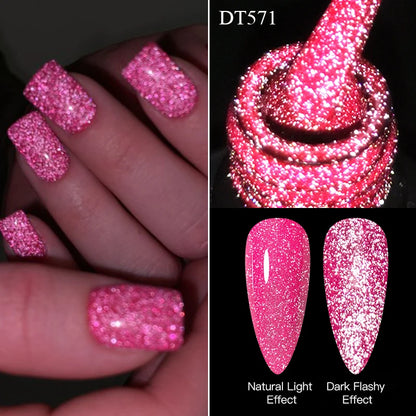 Pink glittery nail polish with natural light and dark flashy effects shown on nails and a swatch.