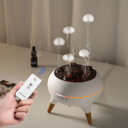 Humidifier with steam rising and a hand holding a remote control on a table.