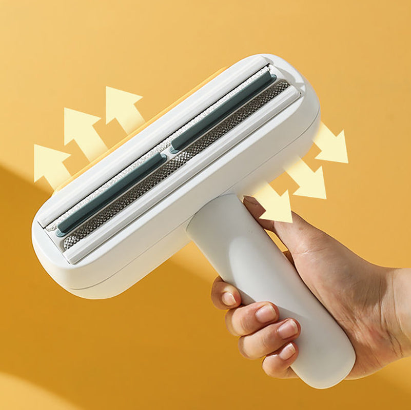 Hand holding a white pet hair remover against a yellow background