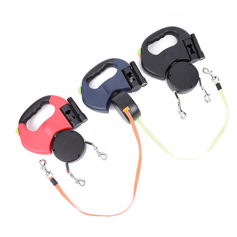 Four retractable dog leashes in different colors on a white background