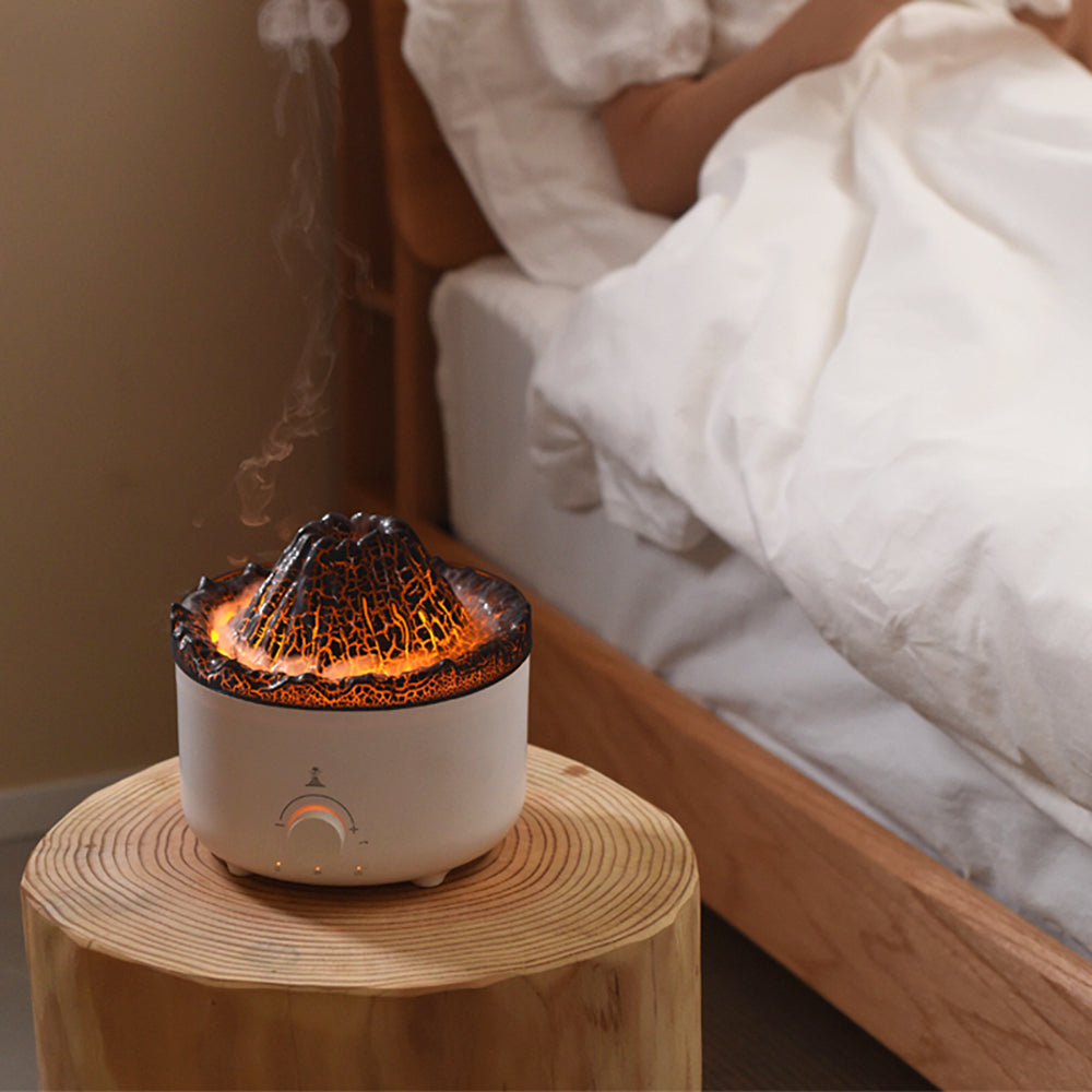 Volcano Flame Humidifier Aroma Diffuser -
Decorative lamp with lava design on a wooden table next to a bed.
