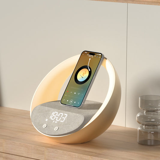 Smartphone on a round, light-colored charging pad with digital display on a wooden surface.