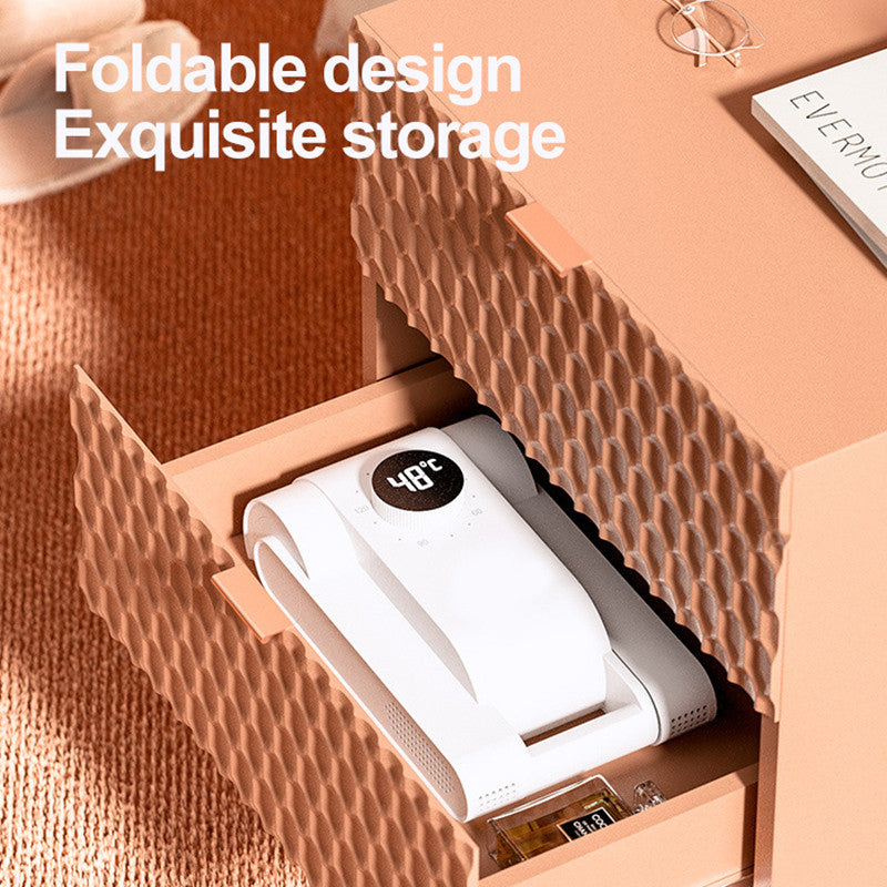 Foldable design storage box with a white electronic device inside, on a textured surface.