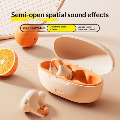 Ear Clip Bluetooth Wireless Headphones - Orange earbud case with earbuds on a beige surface, surrounded by oranges.