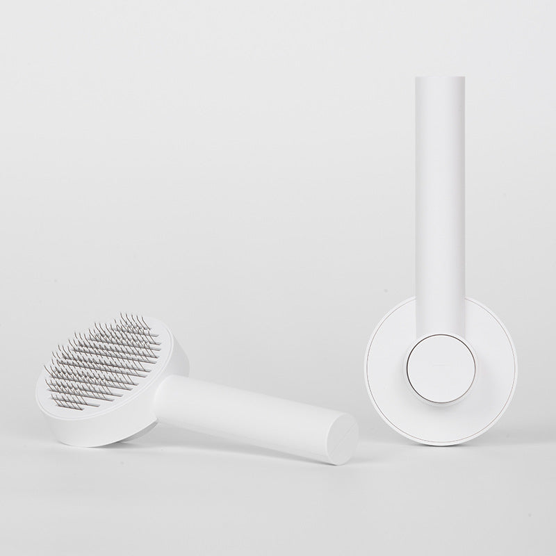 White facial cleansing brush with bristle head on a light gray background