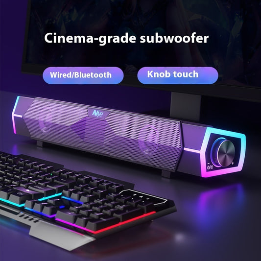 Cinema-grade subwoofer with RGB lighting next to a keyboard on a dark background