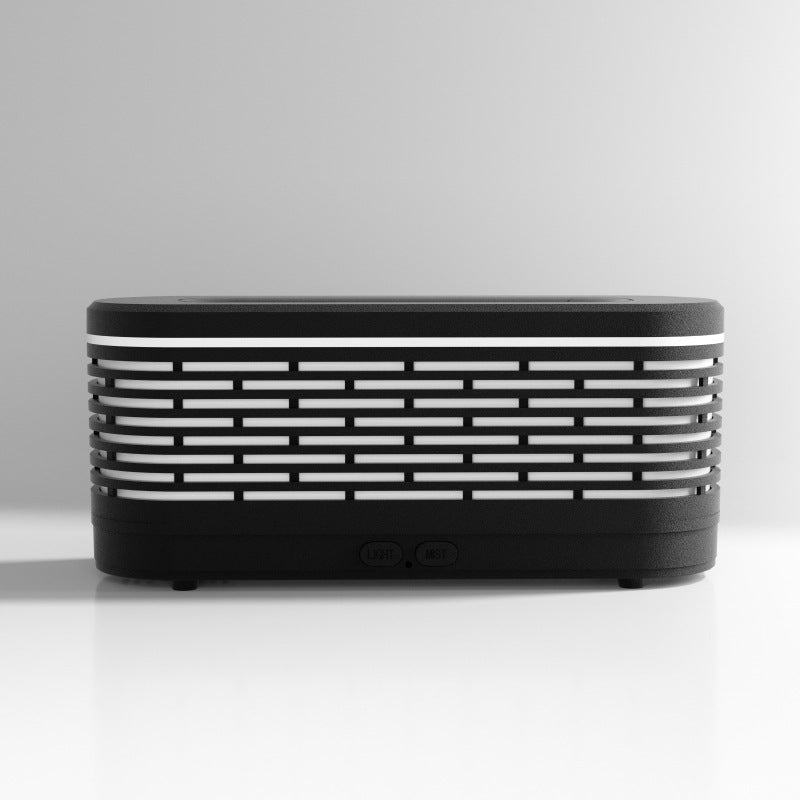 Black and white rectangular device with horizontal stripes on a light gray background