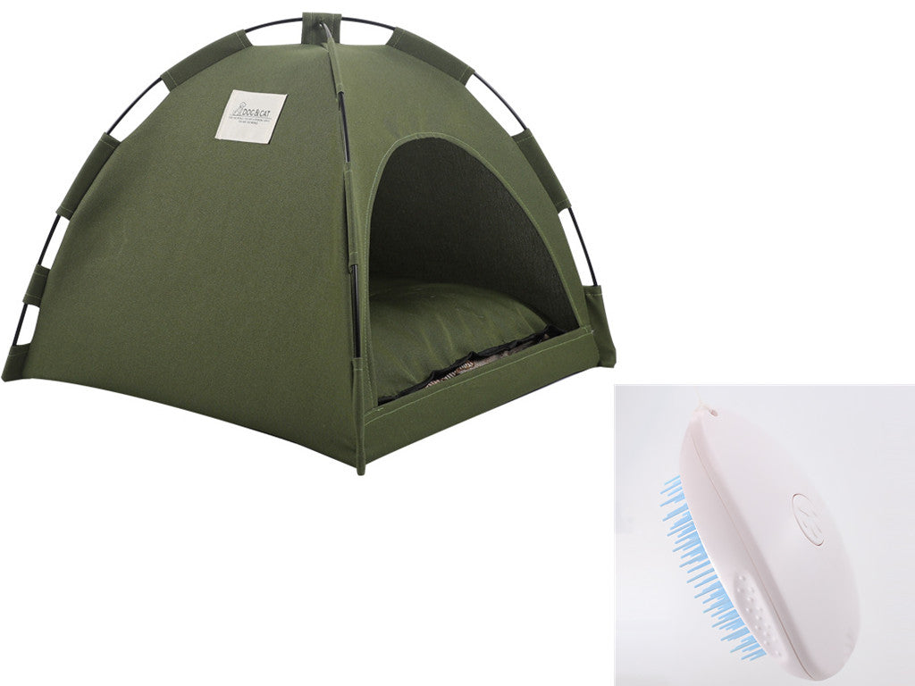 Green tent and white hairbrush with blue bristles on a white background