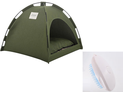 Green tent and white hairbrush with blue bristles on a white background