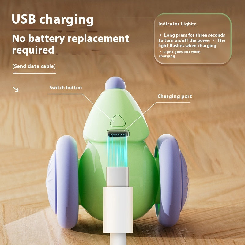 Green and purple robot-like device with USB charging cable on a wooden surface