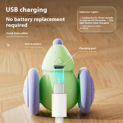Green and purple robot-like device with USB charging cable on a wooden surface